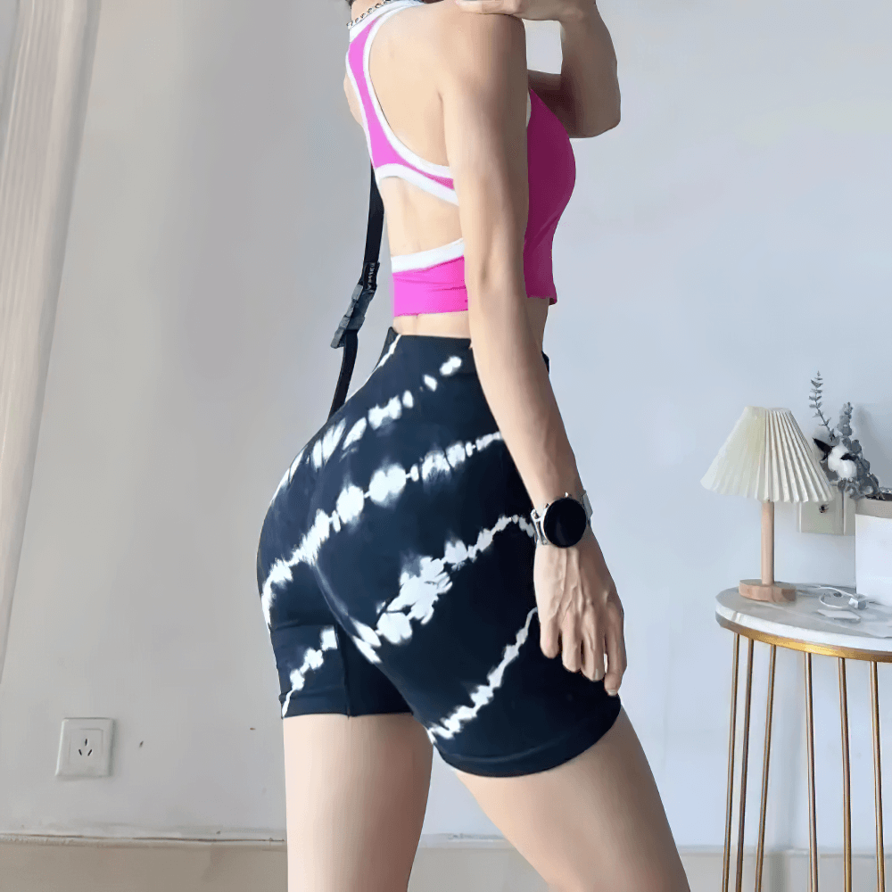 Woman wearing Women's Tie-Dye High Waist Peach Lift Shorts - SF4127, showcasing seamless fit and scrunch detail during workout.