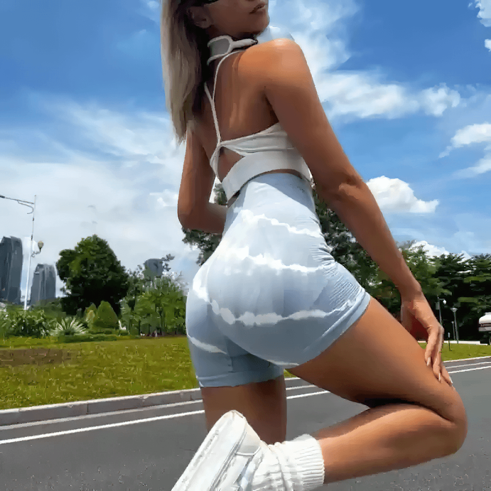 Woman wearing Women's Tie-Dye High Waist Peach Lift Shorts - SF4127, showcasing the seamless 4-way stretch in an outdoor setting.