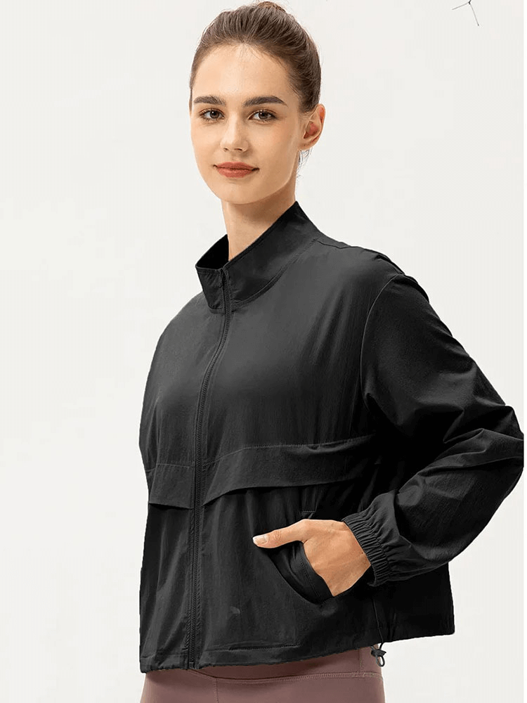 Woman wearing black UV protection running windbreaker with turn-down collar, lightweight and breathable for outdoor sports.
