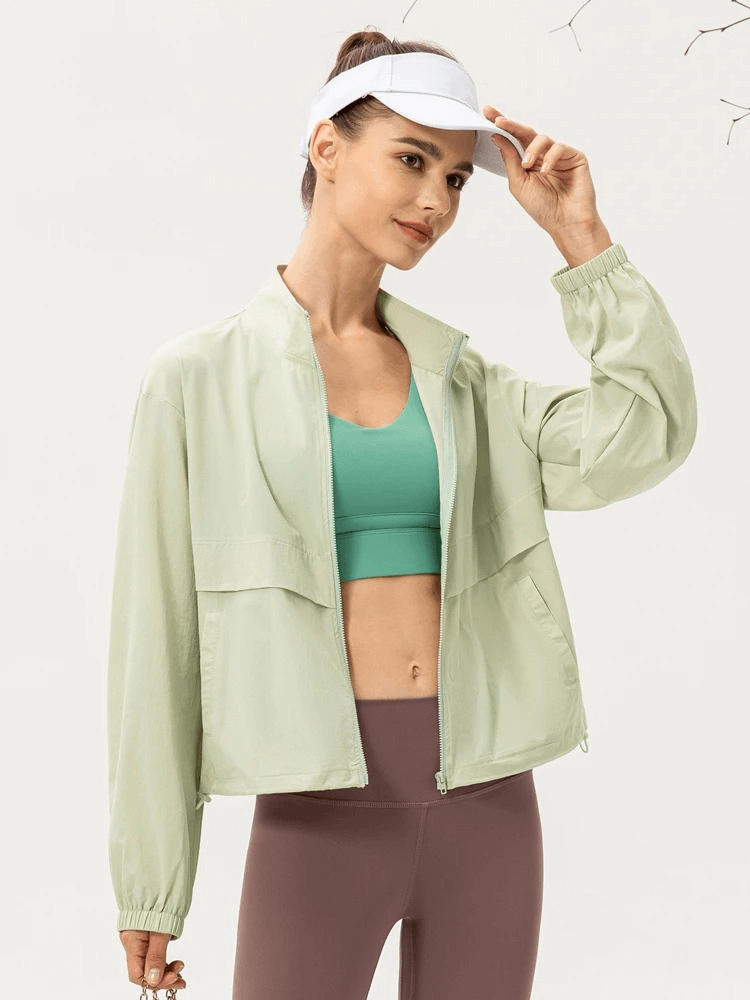 Woman wearing a lightweight UV protection running windbreaker, perfect for outdoor sports, featuring a turn-down collar and breathable fabric.