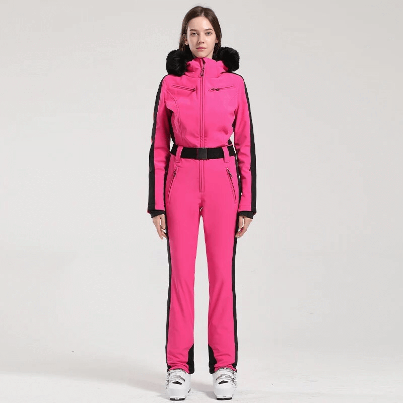 Women's pink ski suit with hood, designed for warmth and protection with water-resistant fabric and stylish black accents.