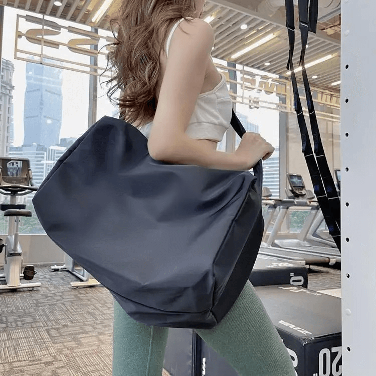 Woman at the gym with a large-capacity waterproof fitness tote bag, perfect for workouts and storing gym essentials securely.