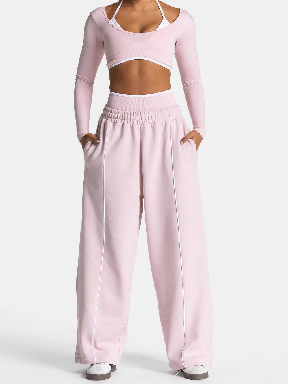 Woman wearing pink Women's Wide-Leg Running Pants with Elastic Waist - SF4264, featuring deep pockets and piping for athleisure style.
