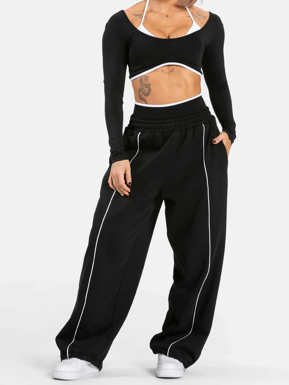 Model wearing Women's Wide-Leg Running Pants with Elastic Waist - SF4264, featuring piping, elastic waist, and deep pockets for active wear.