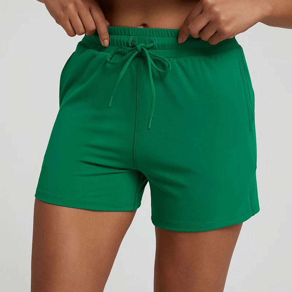 Green women's workout shorts with elastic waistband, perfect for gym or casual wear, offering comfort and flexibility.