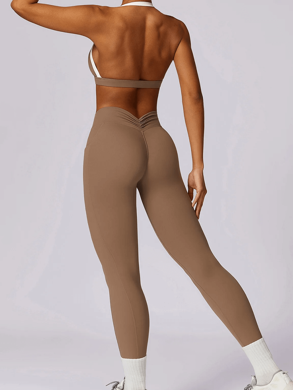 Back view of Women's Yoga Set with sleeveless top and high-waist leggings in brown, ideal for versatile fitness activities.
