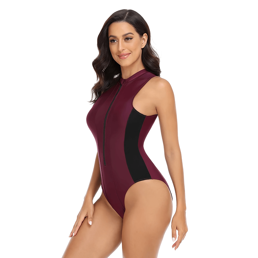 Women's zip-front athletic one-piece swimsuit in maroon and black, sporty design, made from polyester and spandex, model posing elegantly.