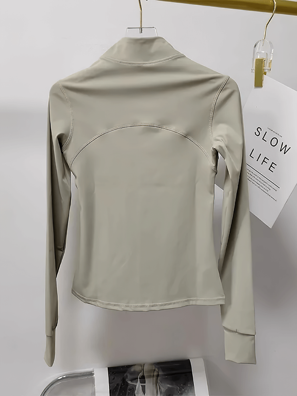 Back view of Women's Zip-Up Running Training Jacket Stand Collar - SF4030 in beige, showcasing its breathable and quick-drying nylon.
