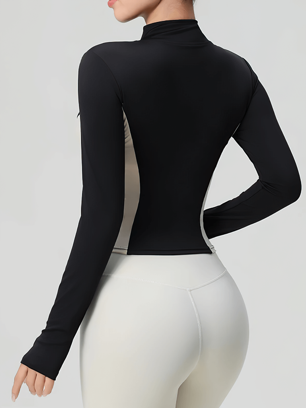 Back view of Women's Zip-Up Turtleneck Yoga Jacket with Thumbholes - SF4050 in black, showcasing long sleeves with finger holes.