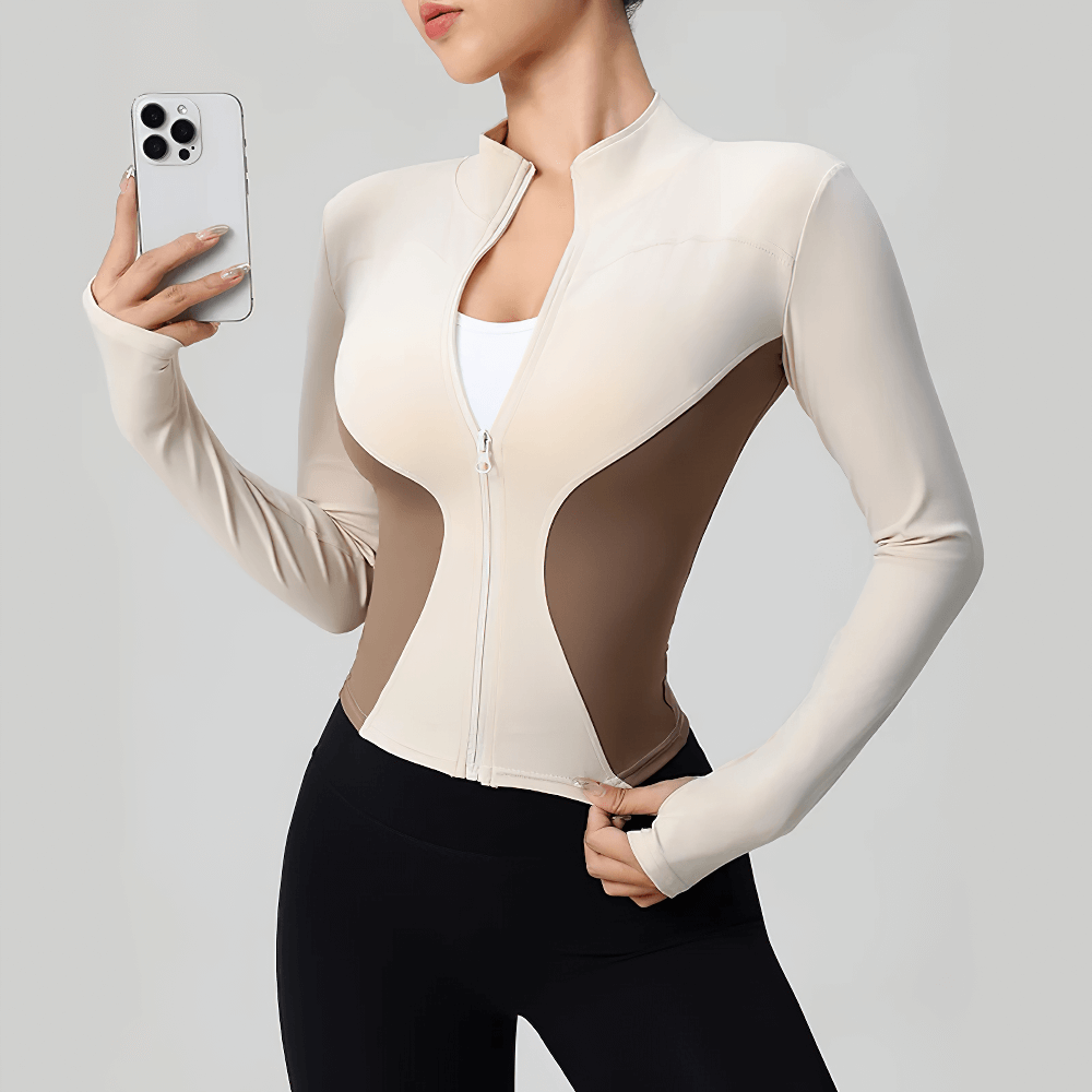 Women's Zip-Up Turtleneck Yoga Jacket with Thumbholes - SF4050 in beige and brown, worn by model holding phone, long sleeves with finger holes.