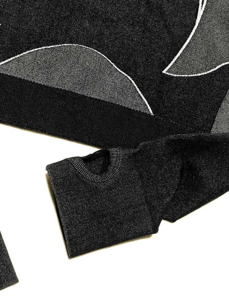 Detailed view of breathable black workout long sleeves suit with subtle pattern, designed for running and fitness activities.