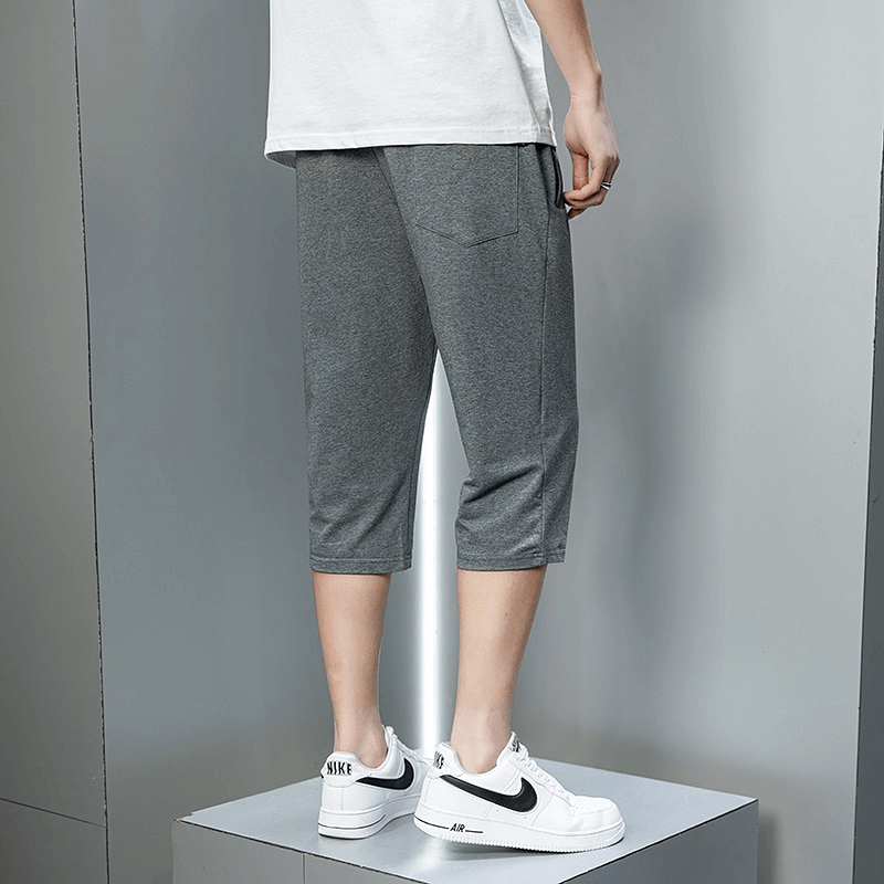 Casual men's sportswear grey breeches with zip pockets and breathable cotton blend for outdoor activities.