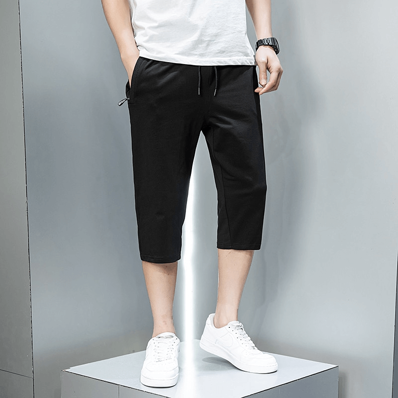 Men's breathable cotton breeches with zip pockets, black color, mid-waisted, drawstring closure, perfect for casual sportswear SF1323