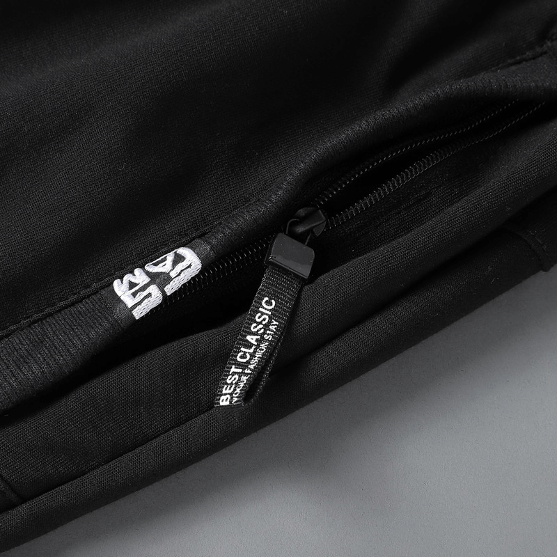 Close-up of black zip pocket on breathable cotton breeches for casual men's sportswear.