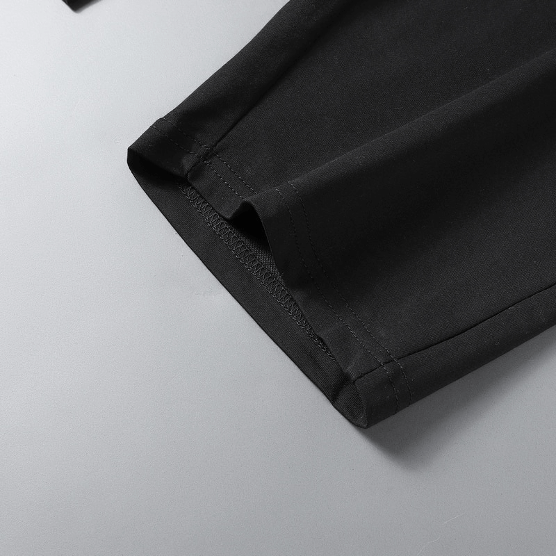 Close-up of breathable cotton breeches with a sleek black finish, showcasing durable stitching for casual men's sportswear.