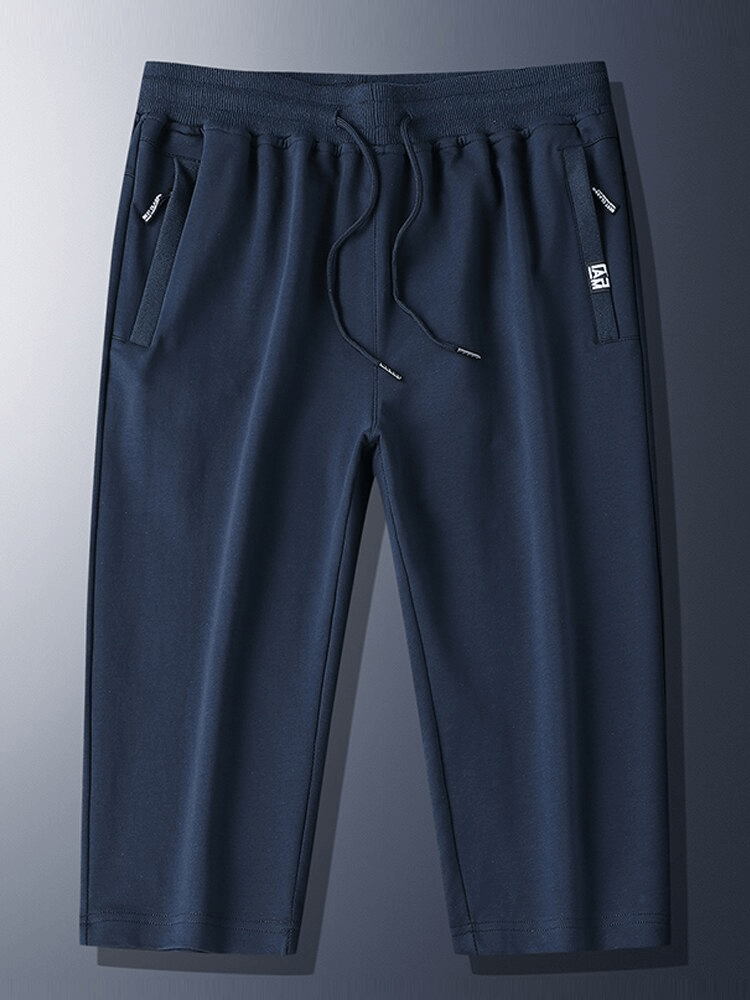 Casual men's sportswear navy blue cotton breeches with zip pockets and drawstring, perfect for outdoor activities.