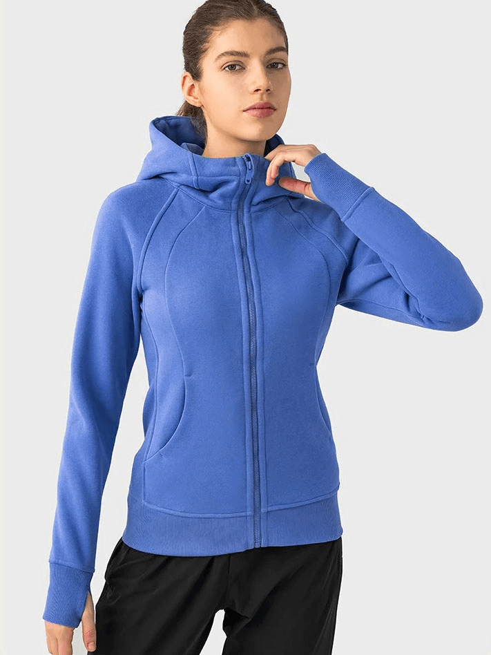 Woman wearing a blue zip-up athletic fleece hoodie with full-length sleeves and stand collar, perfect for comfort and warmth.