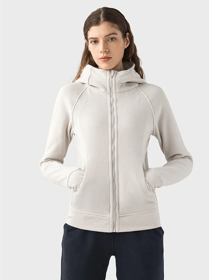 Woman wearing a white zip-up athletic fleece hoodie with stand collar, model SF1919, showcasing full-length sleeves and pockets.