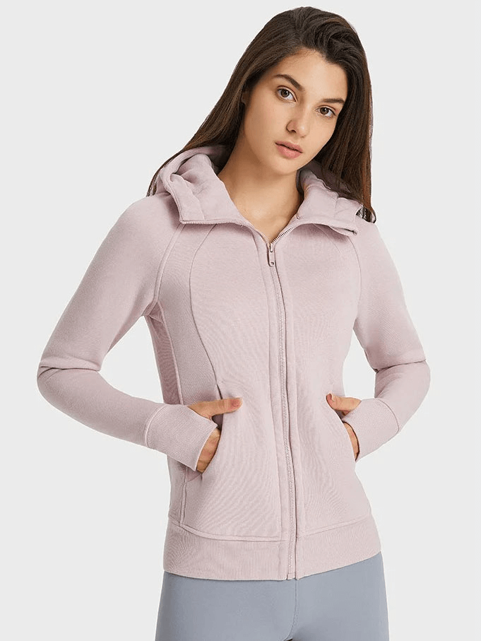 Woman wearing a lilac zip-up athletic fleece hoodie with stand collar and full sleeves, perfect for warmth and comfort.