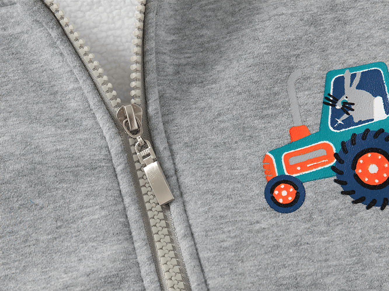 Close-up of Zip-Up Hoodie with Tractor and Car Designs - SF3657 showcasing playful tractor print on soft grey fabric.
