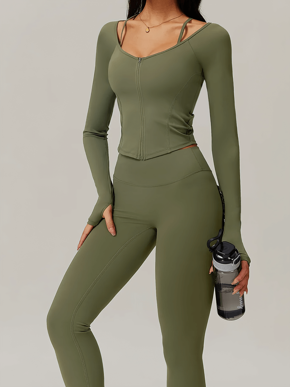 Zip-up long-sleeve yoga top in olive green with thumbholes and quick-dry fabric, perfect for active workouts.