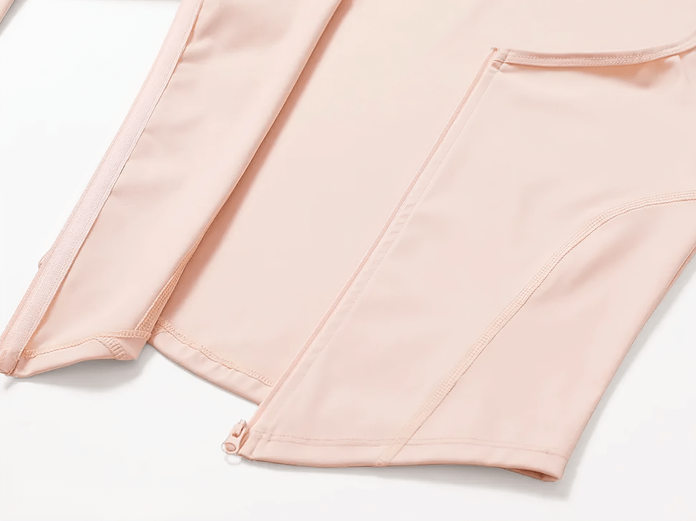 Close-up of a pink zip-up long-sleeve yoga top with sleek stitching and a front zipper detail, perfect for stylish activewear.