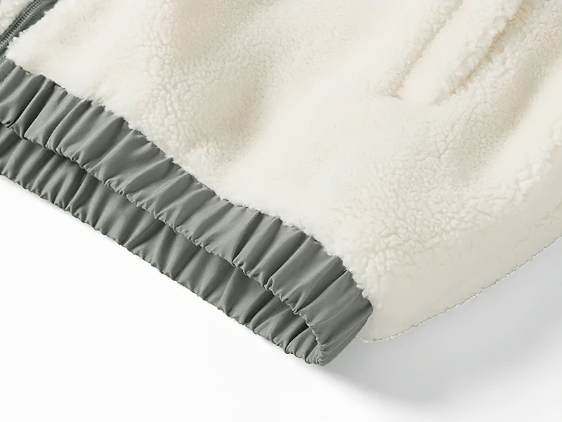 Close-up of Zipper Fleece Loose Fluffy Jacket SF1884, showcasing soft cream fabric and stylish pocket design on hem.