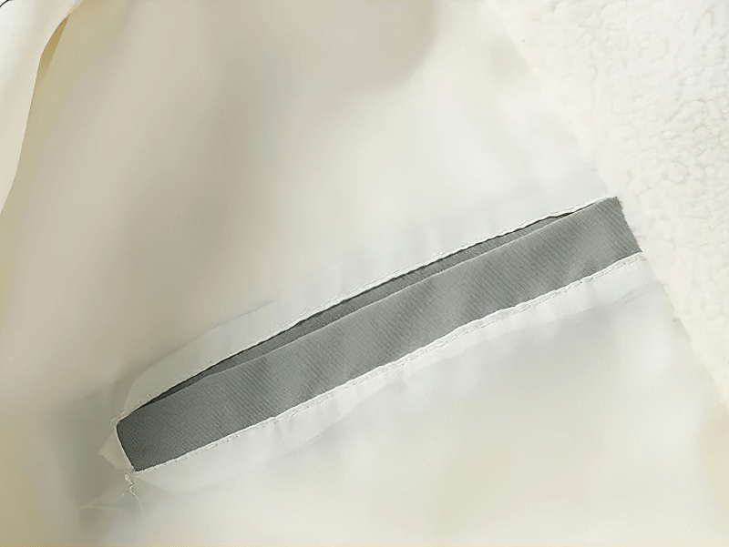 Close-up of zipper fleece lining in a loose fluffy jacket with durable stitching.