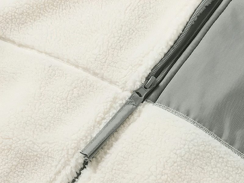 Close-up of zipper on white fluffy fleece jacket with pockets, showcasing durable cotton-polyester fabric. Winter male fashion, SF1884.