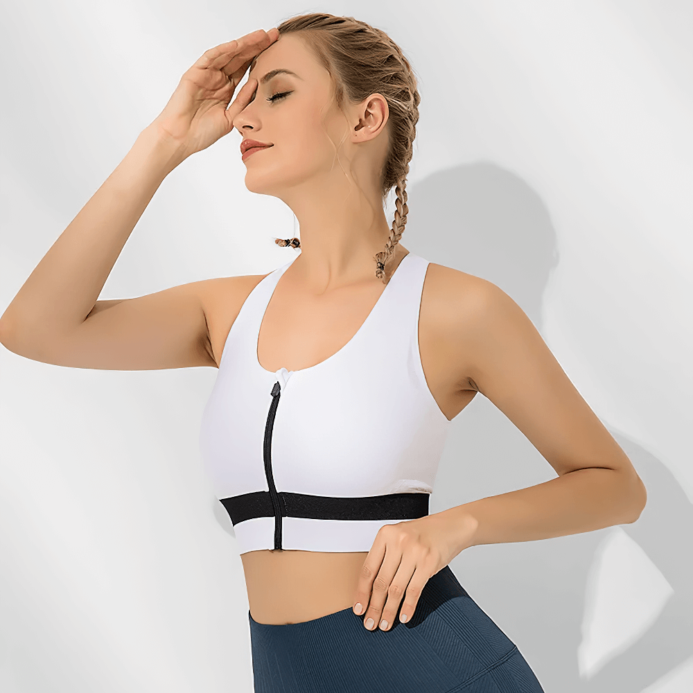 Woman wearing Zipper Front Shockproof Sports Bra SF2334, padded and racerback, perfect for yoga and running with sleek hollow-out design.