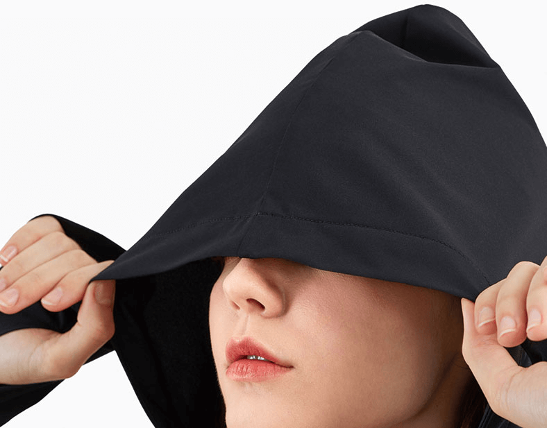 Woman wearing Zipper Hood Loose Fitness Jacket with hood up, focusing on adjustable drawstring feature.