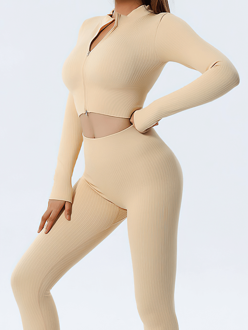 Woman wearing beige zipper long sleeves seamless yoga top and pants set, showcasing sleek design and comfortable fit.