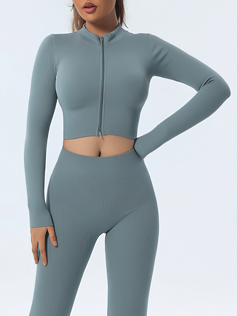 Woman wearing a seamless long-sleeve yoga top with a zipper closure, perfect for fitness activities, in a breathable polyester-spandex blend.