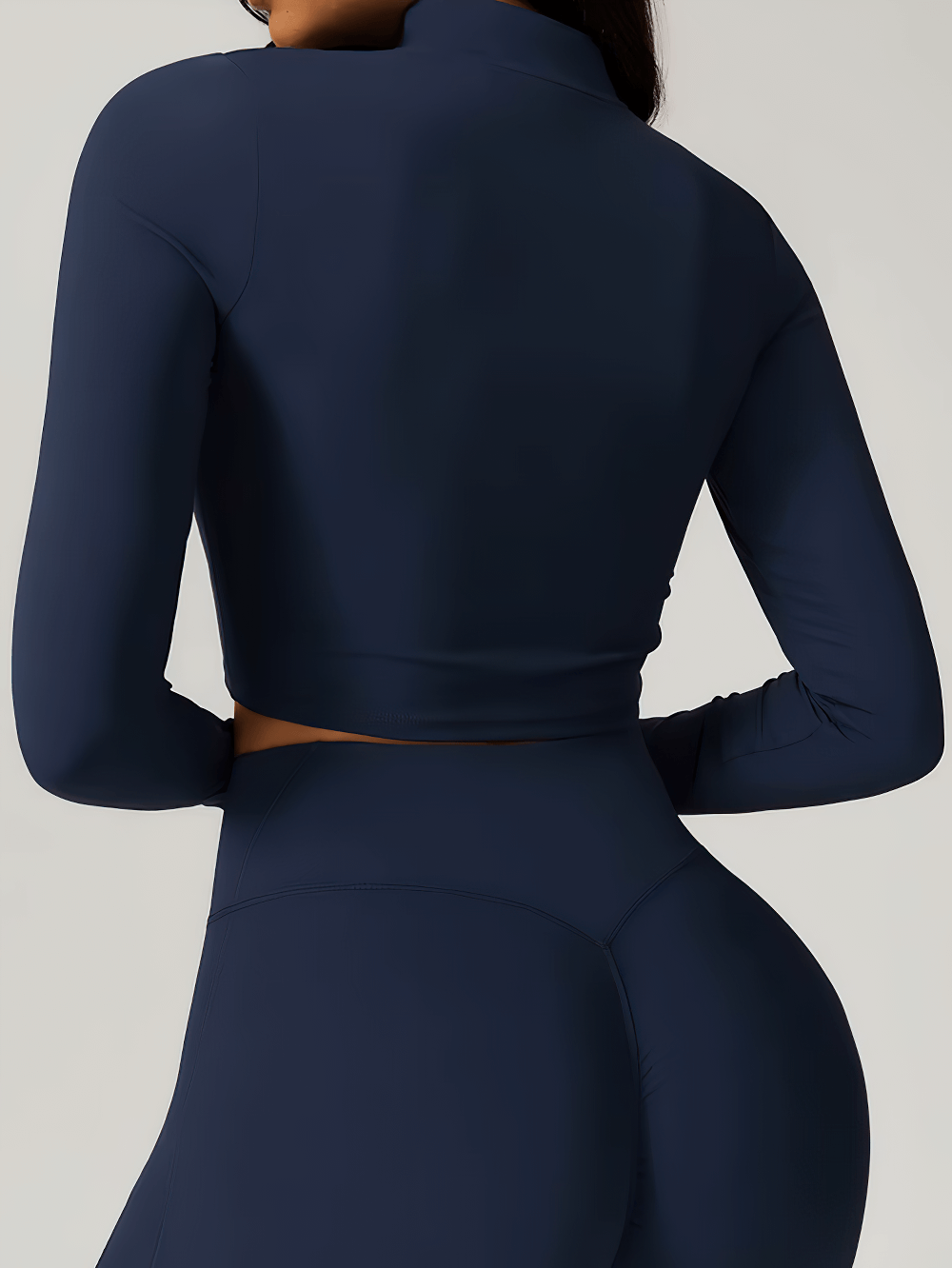 Back view of navy zipper yoga crop top with long sleeves, perfect for workouts and yoga. Anti-pilling, quick-dry, and breathable design.