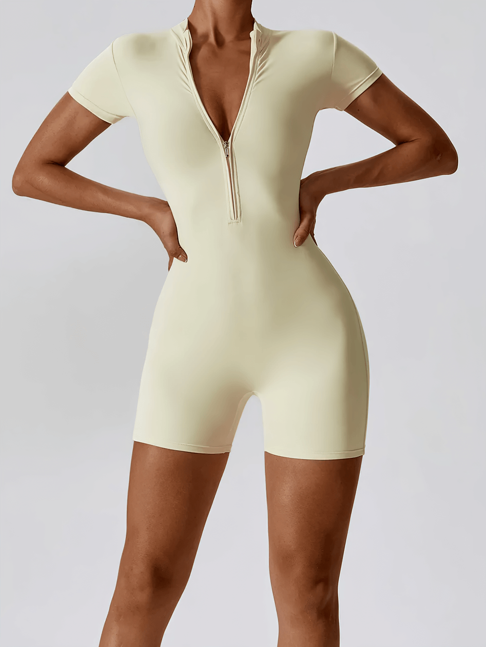 Zippered short-sleeved workout romper for women SF2365, showcasing a chic one-piece design with stretch fabric and tailored fit.
