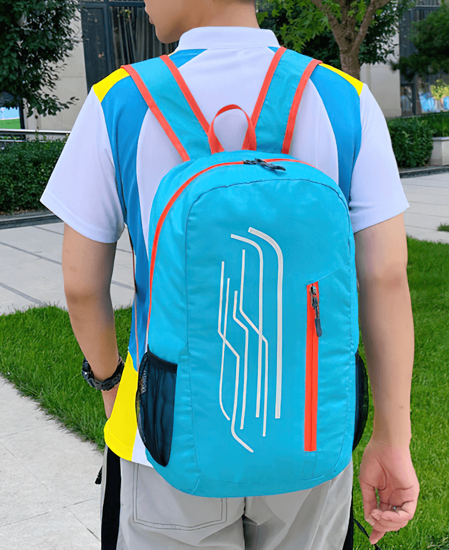 Person wearing a blue 22L Portable Folding Ultralight Cycling Backpack, ideal for biking adventures, with bright accents.