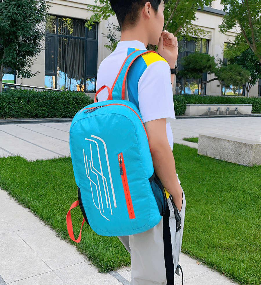 Person wearing a stylish blue 22L folding cycling backpack outdoors, highlighting its lightweight and portable design for active lifestyles.