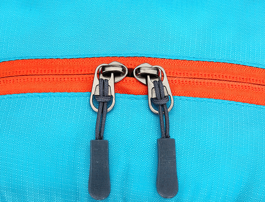 Close-up of blue ultralight cycling backpack with orange zipper, featuring durable stitching and sturdy zip pulls.