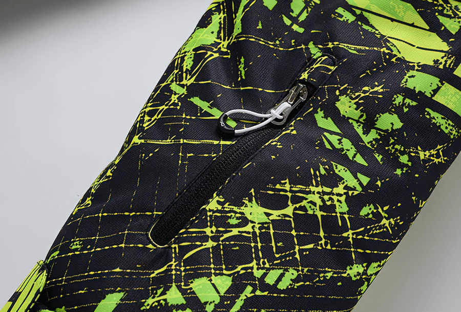 Close-up of colorful waterproof snowboarding jacket fabric with zipper, featuring vibrant abstract pattern and stitching details.
