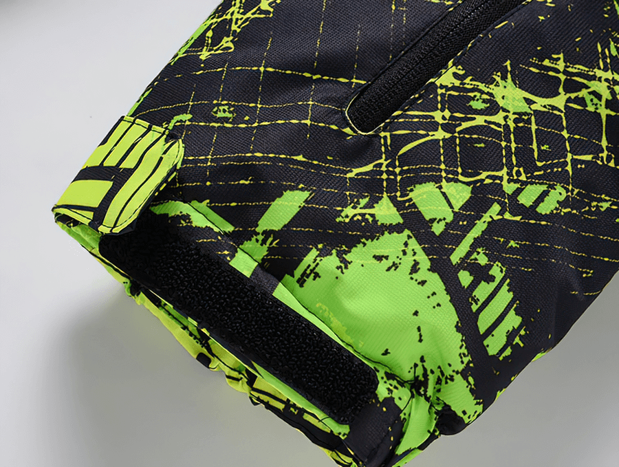 Close-up of colorful waterproof men's jacket sleeve, featuring vibrant yellow and black patterns with secure Velcro closure.