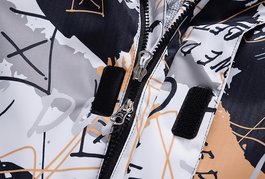 Close-up of colorful waterproof snowboarding jacket zipper and abstract design on Minus 30 Men's Jacket.
