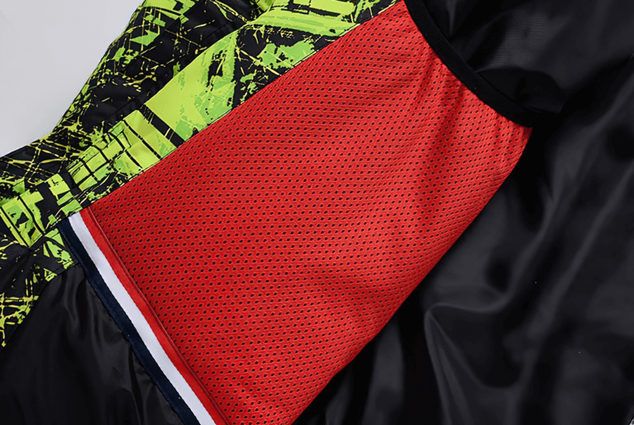 Detail of Minus 30 colorful men's snowboarding jacket fabric with red, black, and neon patterns, showcasing breathable and waterproof design.