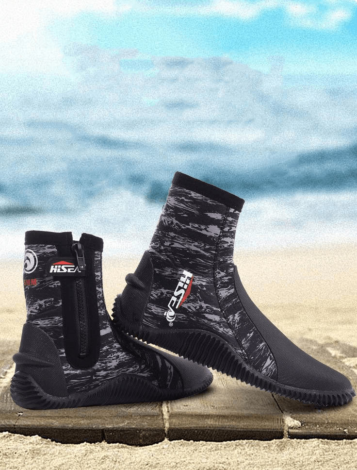 Camouflage neoprene diving boots with zipper on a sandy beach backdrop, ideal for snorkeling and water sports.