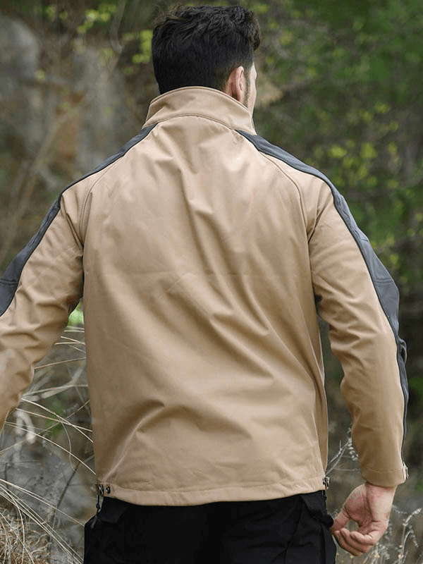 Man wearing beige adjustable cuffs velcro softshell hiking jacket for windproof outdoor adventures.
