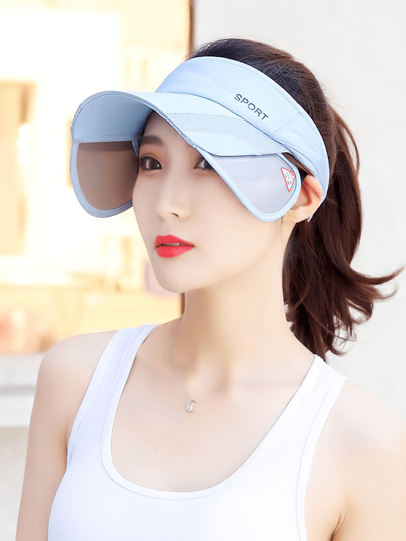 Woman wearing an adjustable strap UV protection sports sun visor in light blue, ideal for golf and outdoor activities.