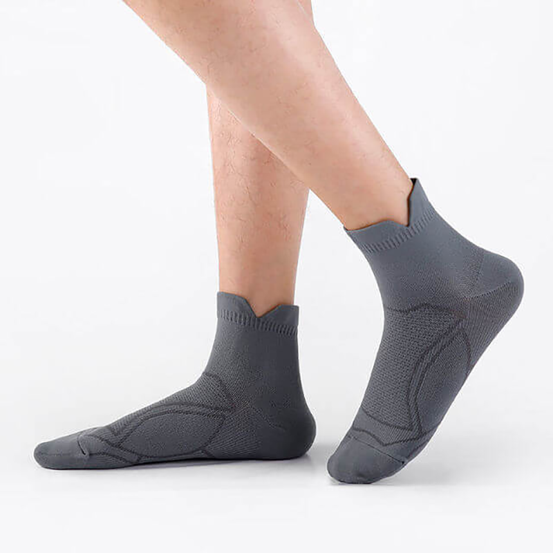 Person wearing gray anti-sweat unisex sport socks, perfect for running and fitness activities, showcasing breathability and comfort.