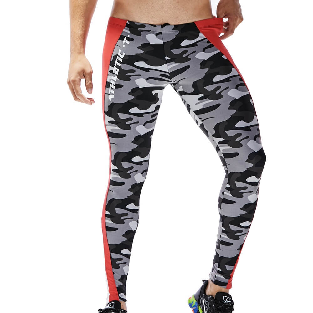 Gray camo men's athletic tights with red stripes, perfect for workouts. Featuring mid-waist and skinny fit design. Model standing.