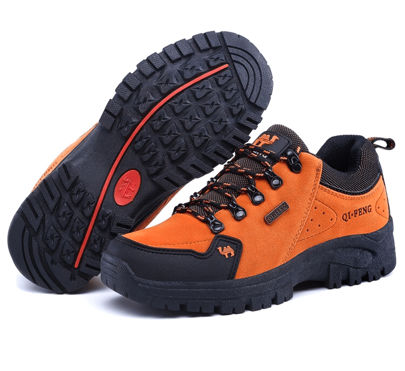 Athletic orange non-slip waterproof hiking shoes with robust traction and breathable leather upper, perfect for outdoor trekking.