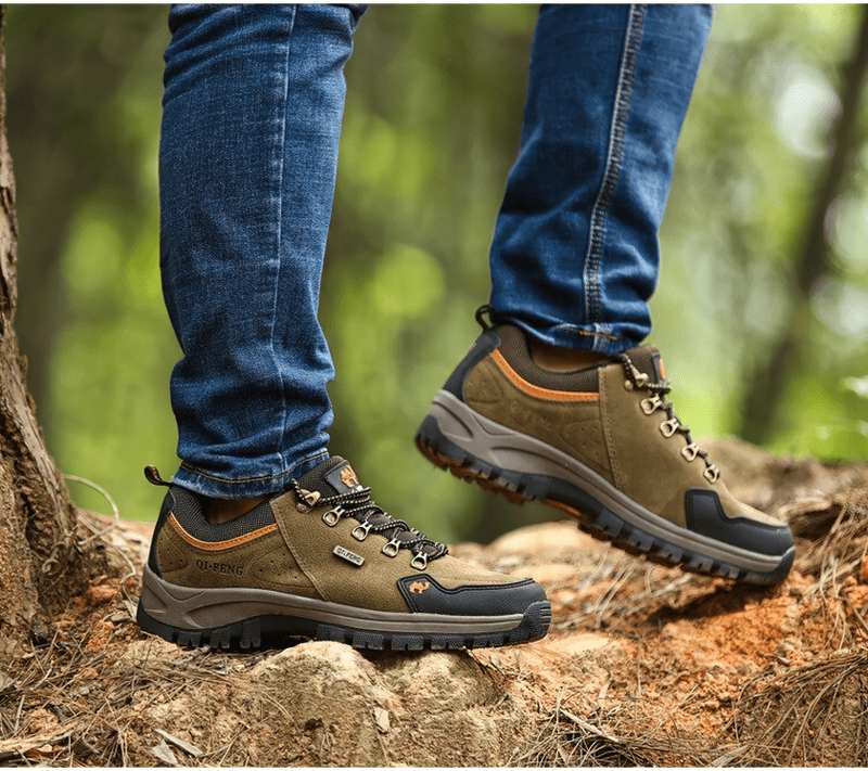 Athletic non-slip waterproof hiking shoes on person trekking through forest terrain, showcasing durability and style.