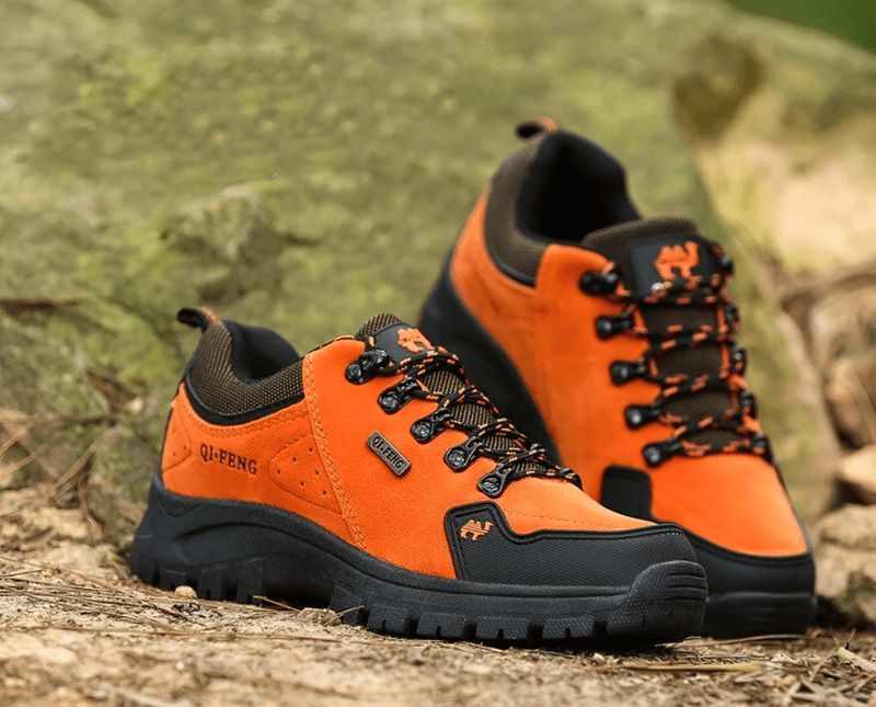 Vibrant orange non-slip waterproof hiking shoes with black accents, designed for maximum outdoor performance and comfort on any terrain.
